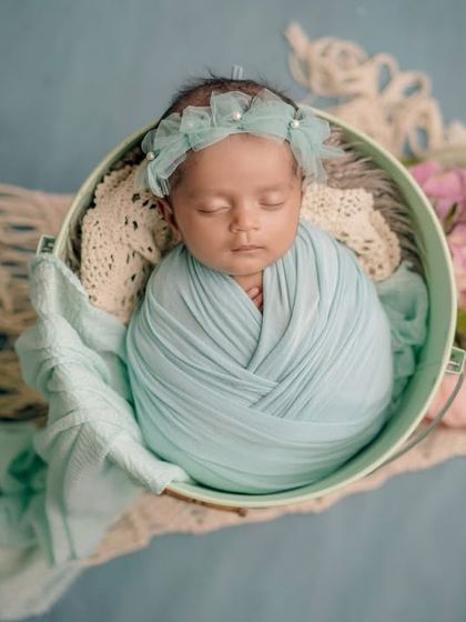 A bucket of blue. This setup combines a classic swaddle with a rustic bucket and soft macrame for a beautiful, textured portrait.