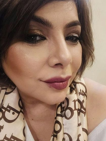 A close-up selfie showing the detailed eye makeup and flawless lip color. This look proves that glam is for every age.
