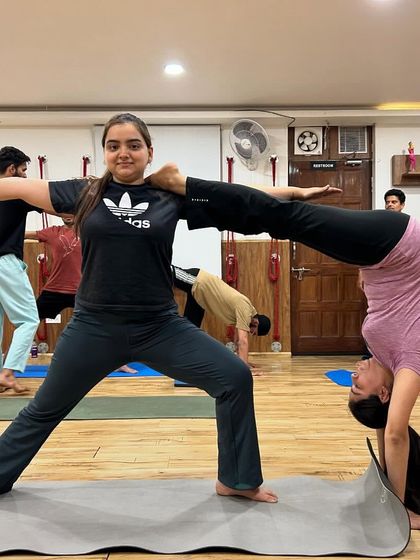 This partner pose showcases incredible trust and core strength. It's a beautiful example of how we can support each other to create amazing shapes.