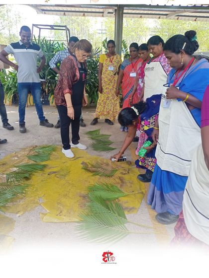 A practical lesson in adding color and texture. Participants at our Nellore workshop learn spray painting techniques on foliage, a creative method to enhance their floral designs and add a unique artistic touch to their work.