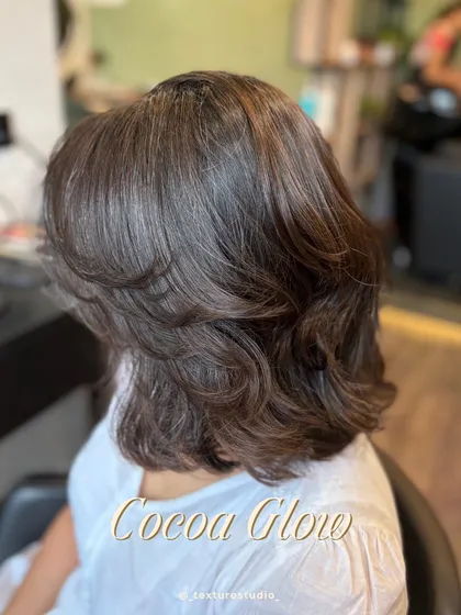 This Cocoa Glow is a rich, single-process color on a layered bob. It proves that you don't always need highlights for a high-impact, glossy finish.