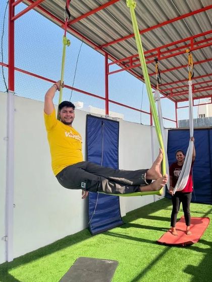 A happy student enjoying the feeling of being supported by the hammock.