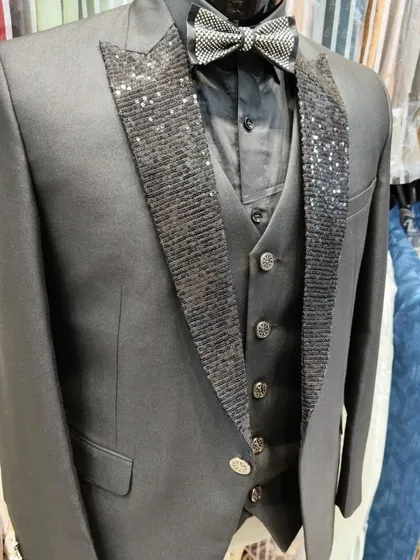 A collection of our designer suits, showcasing a variety of colors, fabrics, and custom details like embroidery, unique lapels, and accessories. Each piece is crafted to make a lasting impression.