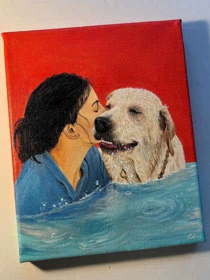 A vibrant and emotional pet portrait of a woman kissing her golden retriever in the water. The bright red background makes the blue water and the subjects pop.