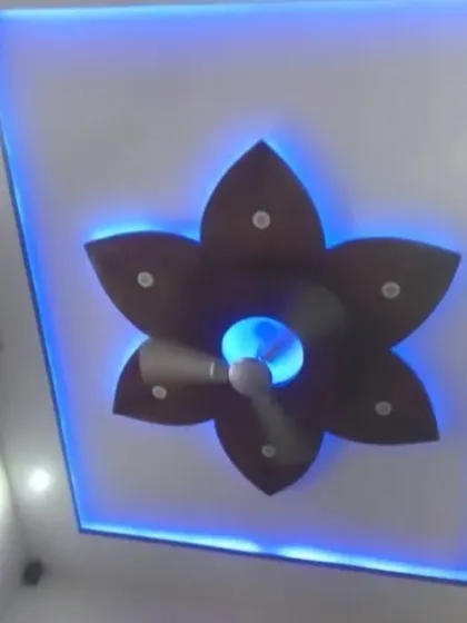 This flower-shaped design is made from wood-finish PVC panels. The blue backlighting gives it a cool, modern glow, and the center is fitted with a fan.