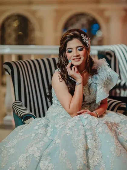 A beautiful portrait of the bride. Her makeup is elegant and glamorous, with a focus on her sparkling blue eyes.