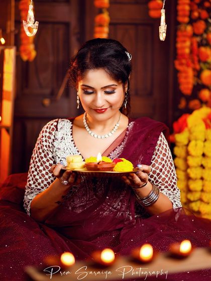 A close-up of the Diwali makeup, with shimmering eyeshadow and perfectly defined features, illuminated by the soft light of a diya.