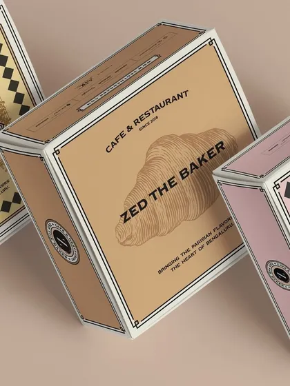My packaging designs are as artisanal as my food. These boxes feature different illustrations, including a classic croissant, reflecting the French-inspired identity of my brand.