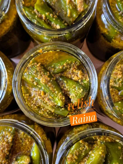 My Stuffed Green Chilli Pickle, or Hari Mirch ka Bharwa Achaar, is a North Indian favourite. I use a special medium-spicy chilli called Achaari Mirchi, slit it, and stuff it with a flavourful masala. This top-down view shows the jars just after packing, with the chillies soaking in mustard oil.