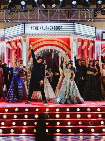 A full-blown Bollywood movie theme. We designed this stage to look like a vintage movie theatre, complete with a custom hashtag marquee, creating the perfect setting for a night of filmy performances.