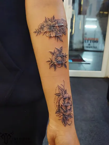 This client wanted to turn a history of self-harm scars into something beautiful. We designed a delicate floral piece that flows along the forearm, using fine-line flowers and soft shading to completely conceal the scars and create a new, positive story.