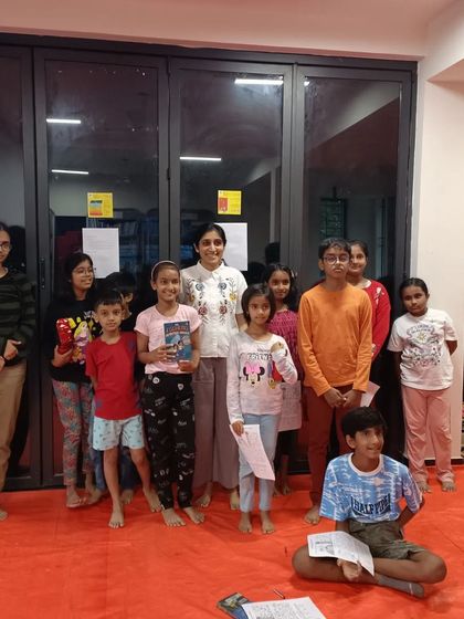 A group of happy kids with author Pika Nani after a fun-filled detective session. Everyone is ready to solve their next mystery!