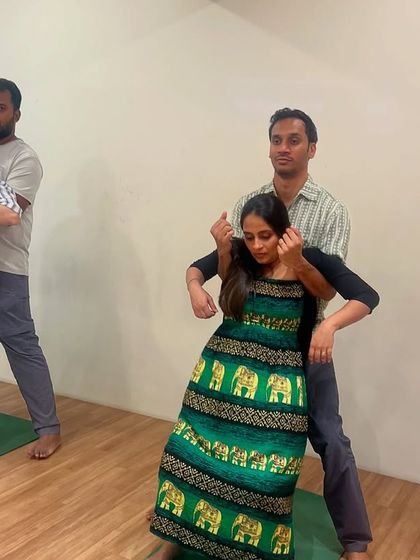 Partners learning the 'lift and tuck' technique. This hands-on support method helps relieve pressure on the lower back and encourages the baby to move into a good position for birth.