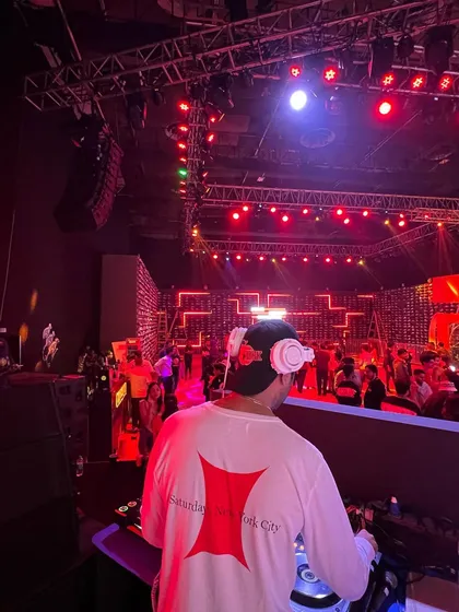 A shot from behind the console at a large-scale event. The red stage lighting and massive crowd created an epic atmosphere for the night.