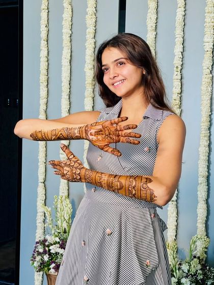 The client showing the front and back of her hands, giving a full view of the design.