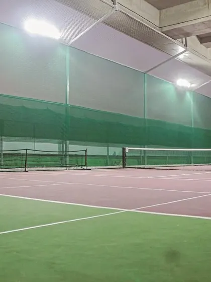 Here's a look at my pristine, all-weather indoor tennis court. With professional-grade surfaces and excellent lighting, you can enjoy a perfect game of tennis any time, day or night, without worrying about the Mumbai weather.