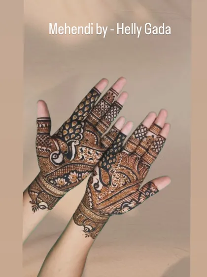 The complete view of the peacock bridal design. The birds face each other across the two hands, symbolizing a loving couple.