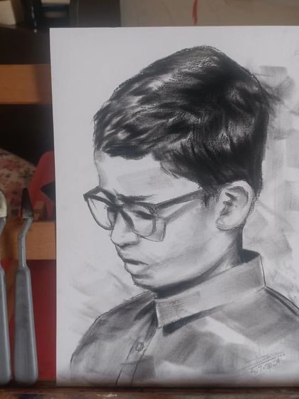 A realistic charcoal sketch of my nephew. Besides caricatures, I also practice and enjoy creating realistic portraits.