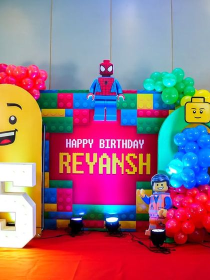 A fantastic LEGO-themed stage with multiple characters, a light-up number '5', and a colorful brick backdrop.