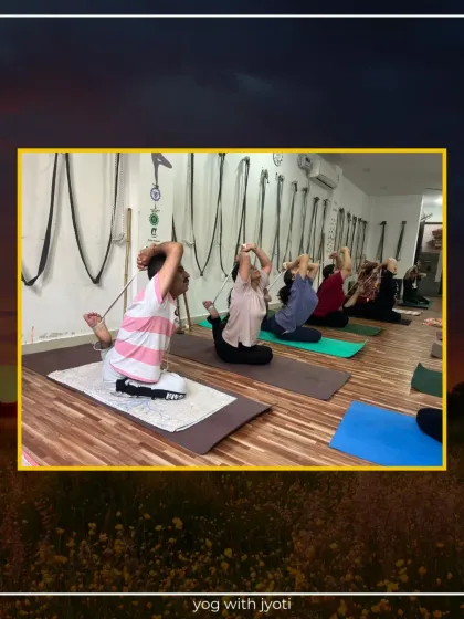 A class practices King Pigeon Pose, each at their own level of flexibility.