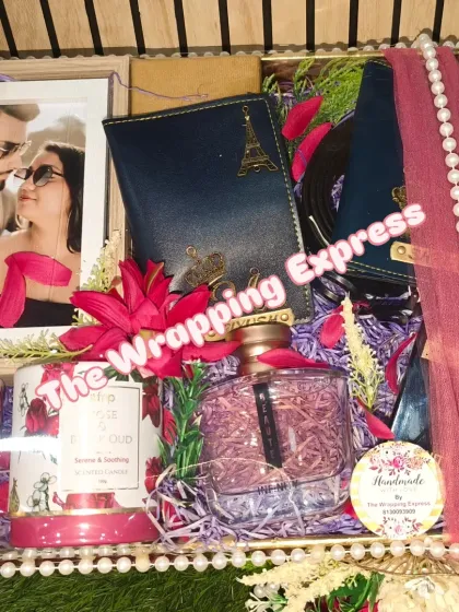 A close-up of the newlywed couple's hamper, showing the details of the personalized passport holders and perfume bottle.