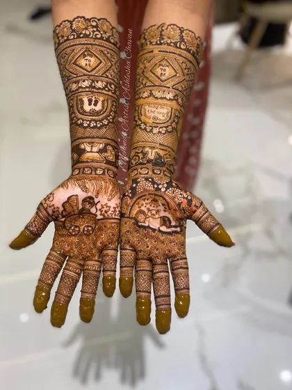 A full-coverage baby shower mehendi with various baby-themed figures and patterns. A beautiful and intricate way to celebrate the mom-to-be.