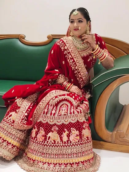 The bride seated, showcasing the intricate details of her lehenga and makeup. The look was designed to be elegant whether standing or sitting.