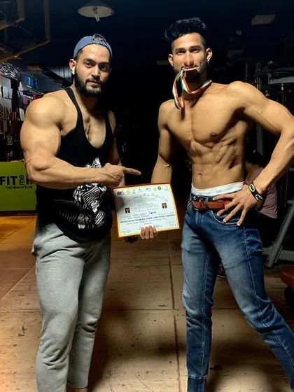 Guiding my client to his win. Holding the certificate of achievement is a proud moment for both coach and athlete. This is the result of a structured training and nutrition plan.