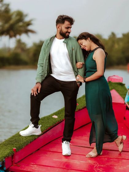 A couple enjoys a moment of quiet connection on a boat, the woman resting her head on the man's shoulder.