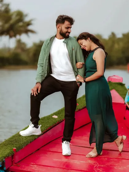 A couple enjoys a moment of quiet connection on a boat, the woman resting her head on the man's shoulder.