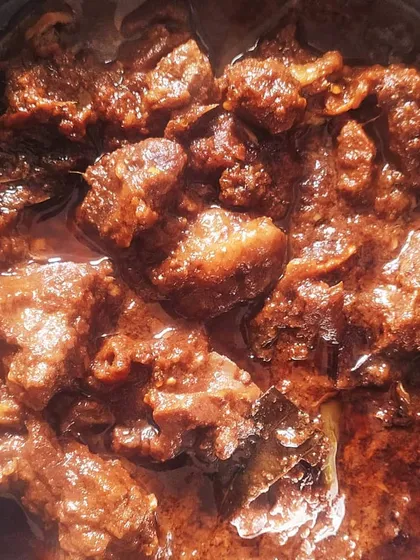 This is Kawsha Mangsho, a timeless Bengali classic. It’s a dry, slow-cooked mutton dish where the magic lies in the caramelization of spices and meat. The rich, dark gravy is perfect for scooping up with luchi or parathas.