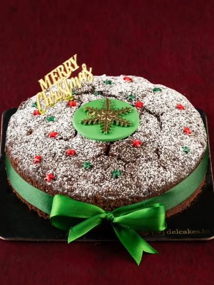 Nothing says Christmas quite like a traditional Plum Cake. Ours is rich, fruity, soaked in rum, and decorated with a festive green ribbon for that extra special touch.