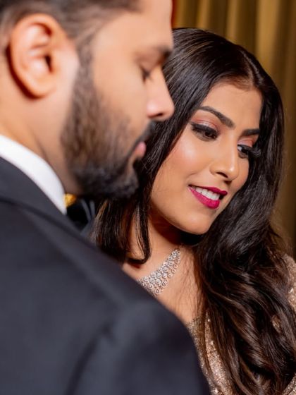 A close-up of the bride's reception makeup, featuring a striking fuchsia lip.