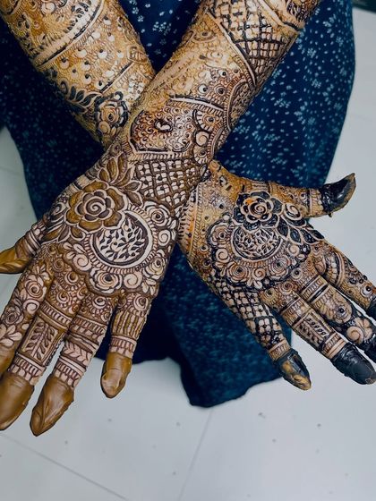 A crossed-hands pose showing the beautiful symmetry and intricate details of this bridal design.