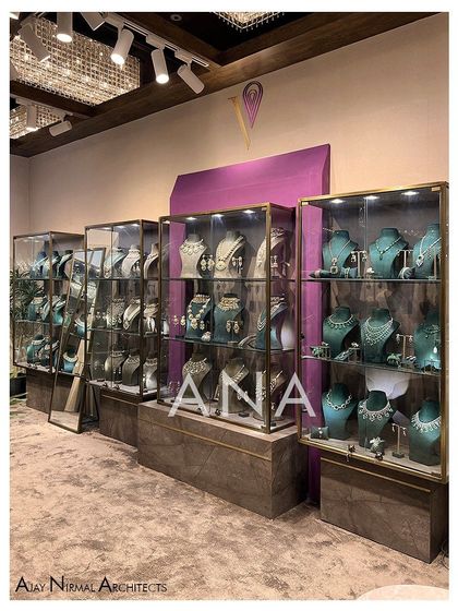 The custom display units for the Villandi '22 collection were designed as sleek glass boxes with brass frames. They appear to float above stone-textured storage bases, enhancing the sense of luxury.