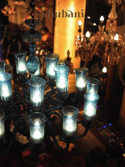 Every piece here reflects timeless royalty. This beautiful blue glass chandelier is just one example of how we bathe our nights in opulence, where modern luxury meets a bygone era.