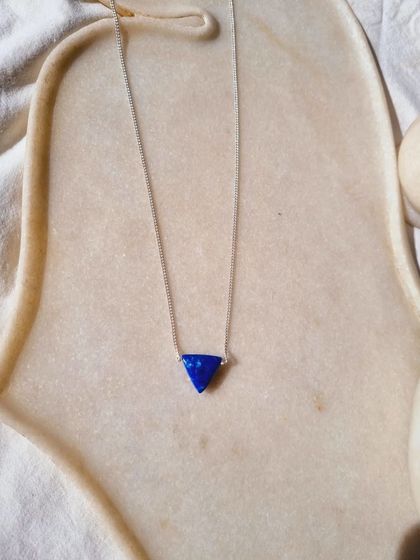 The Lapis Lazuli Tikona pendant for men.