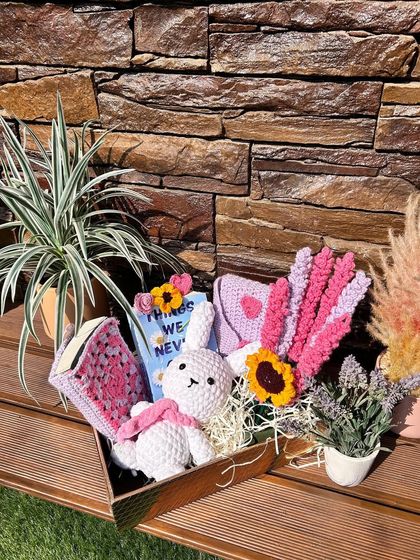 A still shot of our book lover's gift hamper, beautifully arranged with a variety of our handmade crochet items.