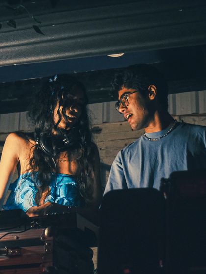 Sharing a moment with a fellow DJ. The scene is all about collaboration and mutual respect.