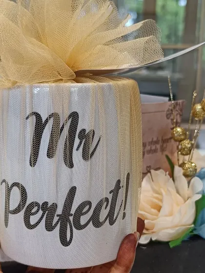 The "Mr. Perfect!" mug, wrapped in delicate tulle, a fun and personal gift for the groom-to-be.
