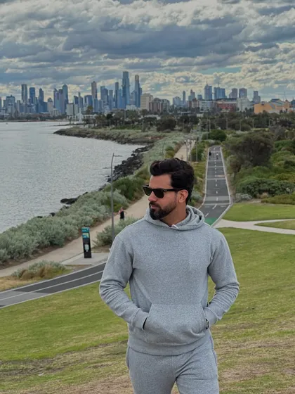 The grey tracksuit shown in a wider shot, perfectly blending urban style with outdoor leisure.