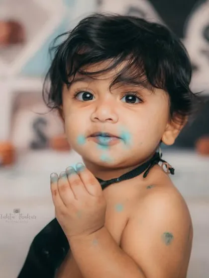 The aftermath of a successful cake negotiation. The blue frosting is evidence of a very happy first birthday.