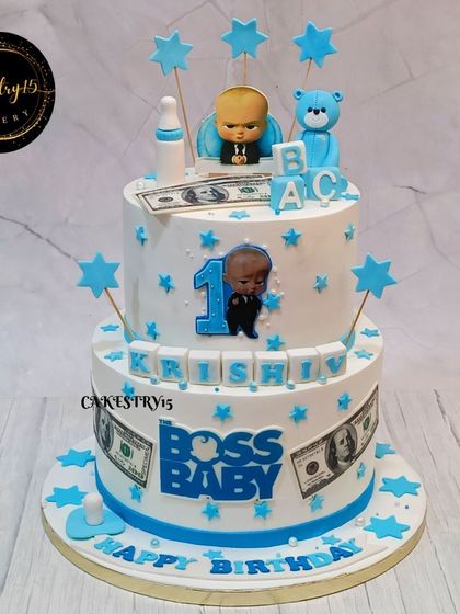 Another take on the Boss Baby theme for a first birthday. This two-tier pineapple cake features blue and white decorations, stars, and the iconic character toppers.