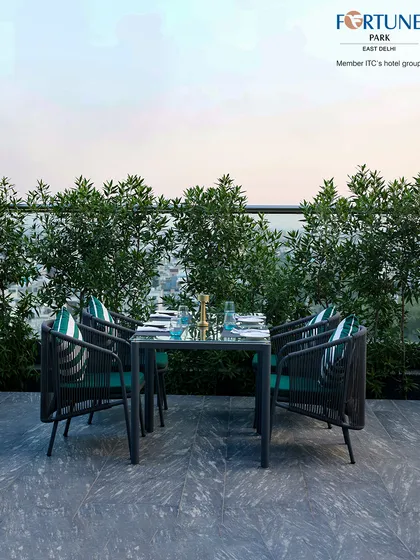 A beautifully set table at Nakshatra, ready for guests to enjoy a meal against the backdrop of the city.