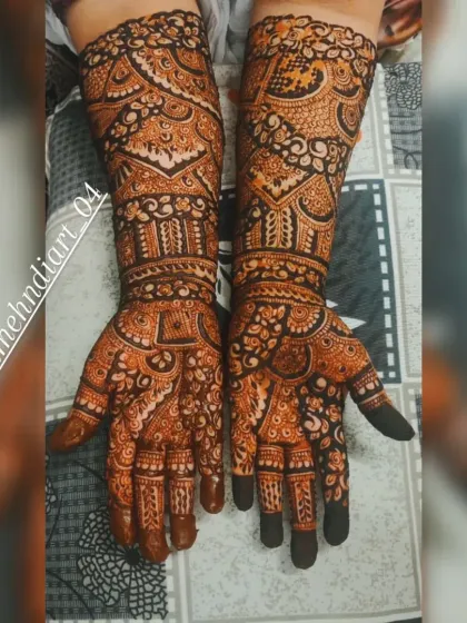 The full glory of a mature henna stain. This deep, uniform colour covers the hands and arms in a rich, traditional pattern.