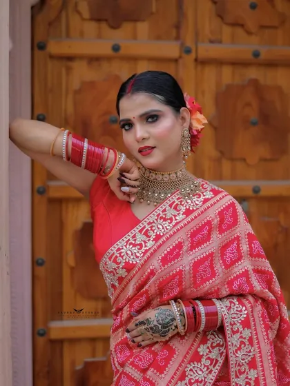 A three-quarter shot with the model leaning against a wooden door, exuding traditional charm.