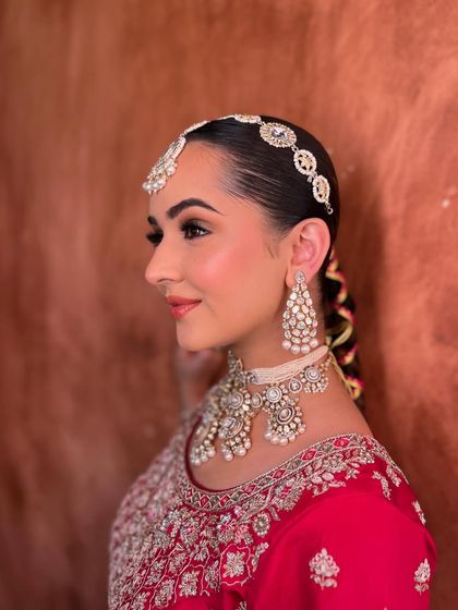 A side profile of this elegant bridal look. You can see the subtle contour and the shimmer on her cheekbones that gives her that beautiful glow.