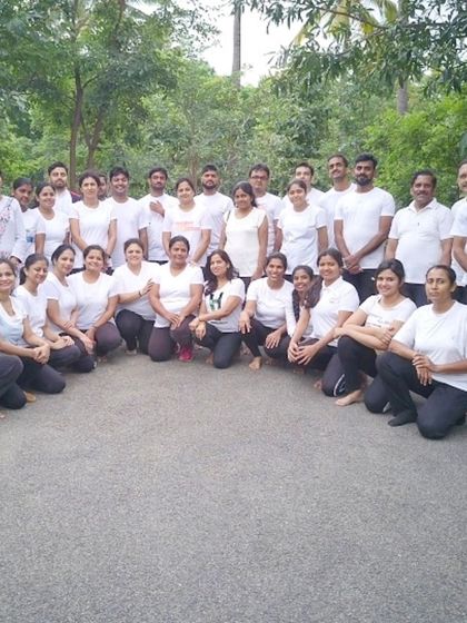 A group photo from one of our outdoor sessions. We believe in taking the practice beyond the studio walls to connect with nature and each other.