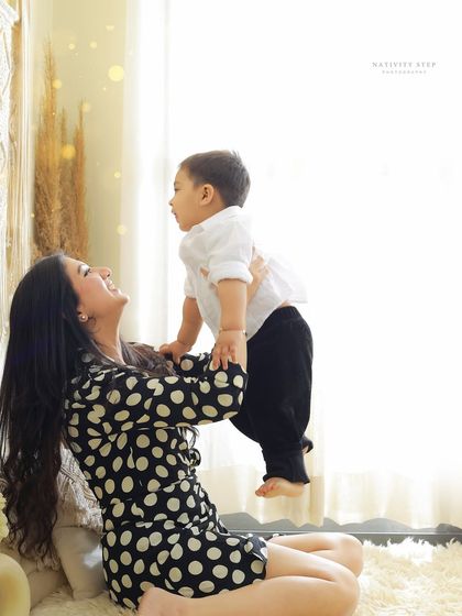 The pure joy of a mother playing with her child. This candid moment, captured in our studio, perfectly shows the loving and playful bond they share.