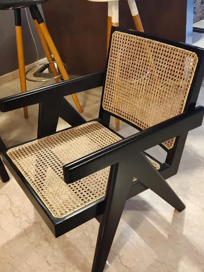 This is my reproduction of the iconic Pierre Jeanneret V-leg armchair, finished in a striking black polish. I build these chairs using solid teak and hand-woven cane, staying true to the original 1950s design principles for a piece that is both a collector's item and a comfortable seat.